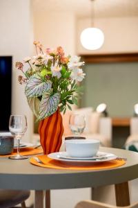 a table with a vase with flowers on it at 森 BREEZE furano MORI in Furano
