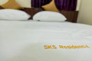 a white bed with the wordyss revision written on it at SKS Residensy in Kāraikkudi