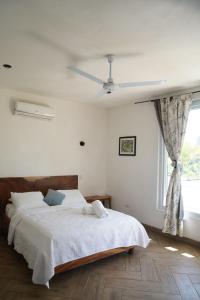 a bedroom with a bed and a ceiling fan at Buena Vista in El Paredón Buena Vista