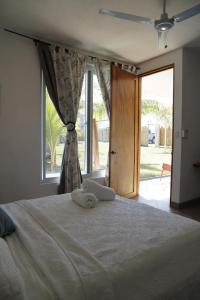 a bedroom with a large bed with a large window at Buena Vista in El Paredón Buena Vista +11 photos