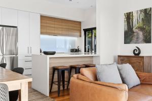 a kitchen and living room with a couch and a table at Vista al Mar in Pohara