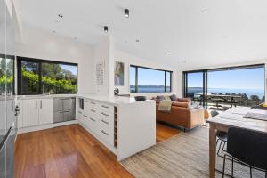 a kitchen and living room with a view of the ocean at Vista al Mar in Pohara +15 photos