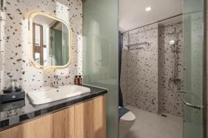 a bathroom with a sink and a mirror at Mai Living Apartment in Danang +12 photos
