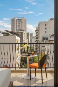 a balcony with a table and a view of a city at Mai Living Apartment in Danang