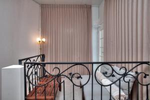 a balcony with a bench and a window with curtains at סוויטות סוויט - Suite in Safed