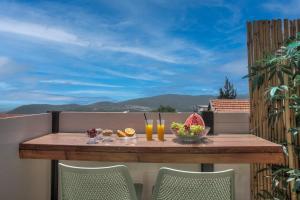 a table on a balcony with drinks and fruit at סוויטות סוויט - Suite in Safed