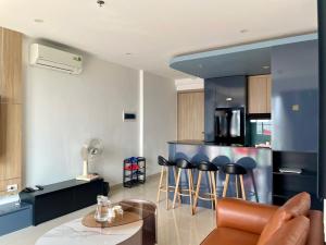 a kitchen with a counter and stools in a room at Căn hộ Vip 2Phòng ngủ - Huế Ơi 3 in Hue