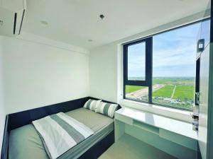 a bedroom with a bed and a large window at Căn hộ Vip 2Phòng ngủ - Huế Ơi 3 in Hue