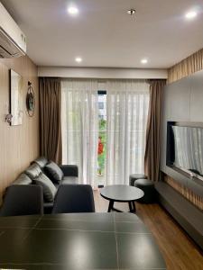 a living room with a couch and a table and a tv at Căn hộ Vip 2Phòng ngủ - Huế Ơi 3 in Hue +17 photos