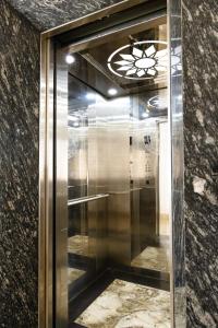 a elevator with a glass door in a building at Sonne Hotel Quang Binh in Dong Hoi