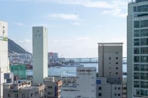 a city with tall buildings and a bridge in the background at Nampo MGM Hotel in Busan