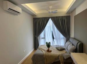 a bedroom with a bed and a window with a potted plant at seroja hills condominium in Sepang