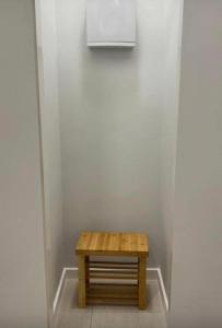 a small wooden table in a corner of a room at seroja hills condominium in Sepang +1 photo