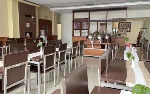 a dining room with chairs and tables in a room at Hortus Inn in Tawangmangu