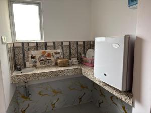 a kitchen with a sink and a refrigerator at Anu Villa Wadduwa in Wadduwa
