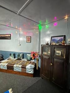a bedroom with a bed in a room with lights at Blue Valley Escape in Darjeeling