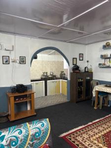 a living room with an archway and a table and a kitchen at Blue Valley Escape in Darjeeling