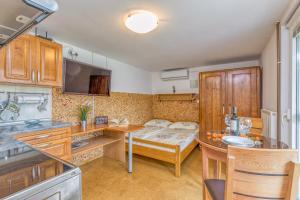 a kitchen with a table and a dining room at River View Suite Mlinar Private Beach - Happy Rentals in Metlika