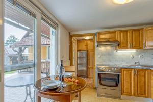 a kitchen with a table and a glass door leading to a patio at River View Suite Mlinar Private Beach - Happy Rentals in Metlika