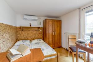 a bedroom with a bed with a book on a table at River View Suite Mlinar Private Beach - Happy Rentals in Metlika +14 photos