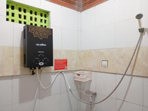 a soap dispenser on the wall of a bathroom at Roemah Djogja Inn Seturan Raya RedPartner in Seturan +23 photos