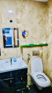 a bathroom with a sink and a toilet and a mirror at The dream studio in Noida