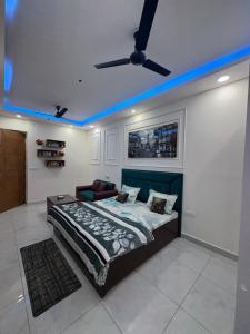 a bedroom with a bed and a ceiling fan at The dream studio in Noida