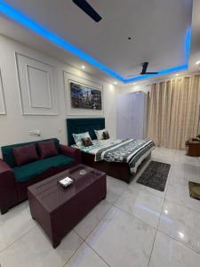 a living room with a couch and a bed at The dream studio in Noida