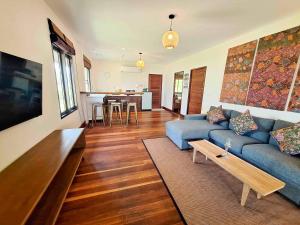 a living room with a blue couch and a table at Baan Manali Resort in Thong Sala