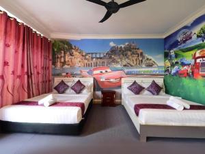 two beds in a room with a painting on the wall at Seeds Hotel Shah Alam Seksyen 7 I-City in Shah Alam +20 photos