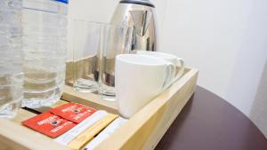 a shelf with cups and glasses on a table at La Roche Hotel Sigiriya in Sigiriya