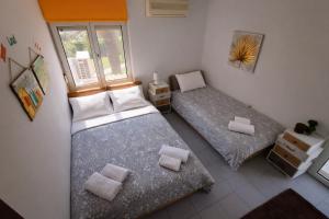 a bedroom with two beds and a window at Las Palmas in Kavála
