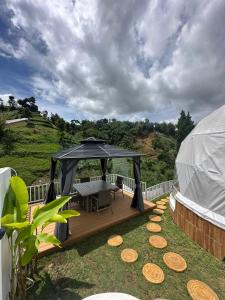 a gazebo with a table and chairs on a deck at Naima 1 in Bandung