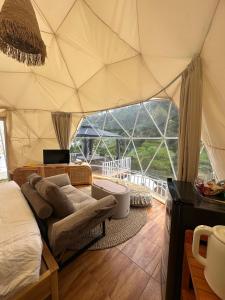 a room with a tent with a bed and a couch at Naima 1 in Bandung