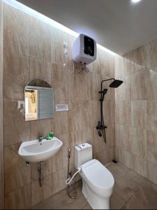 a bathroom with a toilet and a sink at Naima 1 in Bandung