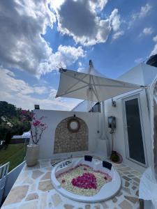 a large white umbrella sitting on top of a patio at Naima 1 in Bandung