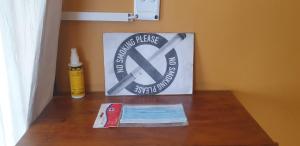 a sign that says no smoking devices on a table at Paradise Camp Rooms in Groutfontein
