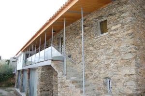 a stone building with a staircase on the side of it at Quinta dos Castanheiros - Turismo Rural in Negreda