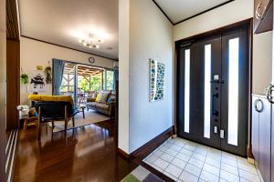 a living room with a door leading to a dining room at Unbi Stay in Nakijin