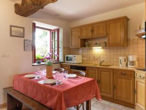 a kitchen with a table with wine glasses on it at Charming Holiday Home in Bonnemain overlooking a Pond in Bonnemain