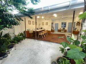 a patio with a table and chairs in a house at Thulusdhoo Garden Villa in Thulusdhoo