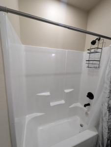a white bathroom with a tub and a shower at Special Deal on Booking Unit-558 in Paris +5 photos