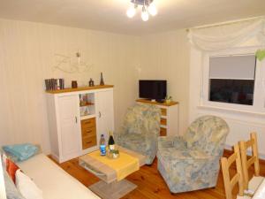 a living room with two chairs and a tv at Quaint Holiday Home in Schmogrow Fehrow in Schmogrow