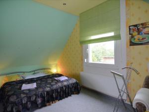 a bedroom with a bed and a window at Quaint Holiday Home in Schmogrow Fehrow in Schmogrow