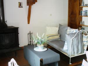 a living room with a couch and a table at Holiday home with terrace in Villeneuve-dʼAllier