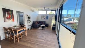 a living room with a table and a couch at il Villinno on Dalton - Great Location in Mosman Park