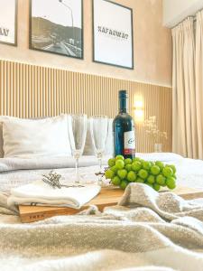 a table with wine glasses and grapes on a bed at Mi Casa de Baguio by North Sierra in Baguio