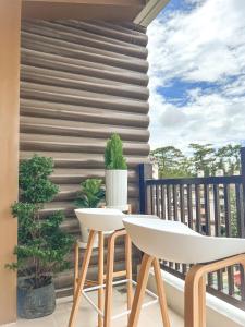 a patio with a white table and chairs on a balcony at Mi Casa de Baguio by North Sierra in Baguio