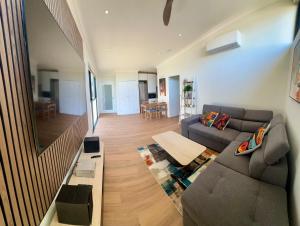 a living room with a couch and a table at il Villinno on Dalton - Great Location in Mosman Park
