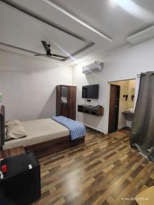 a bedroom with a bed and a television in it at Hotel Jatra in Sillod +23 photos